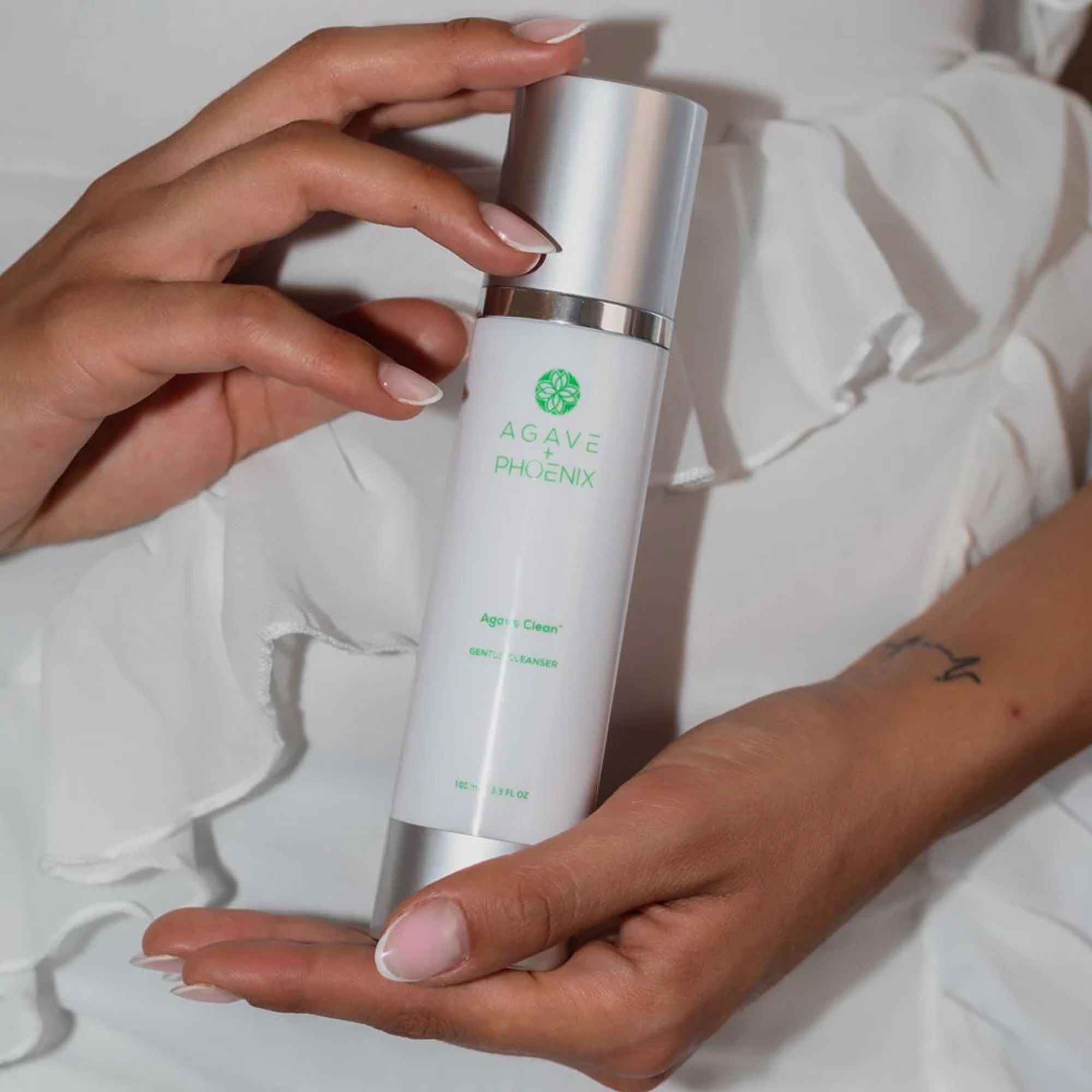 Agave Clean exfoliating cleanser bottle held in hand — gentle, balanced skincare for refreshed skin.