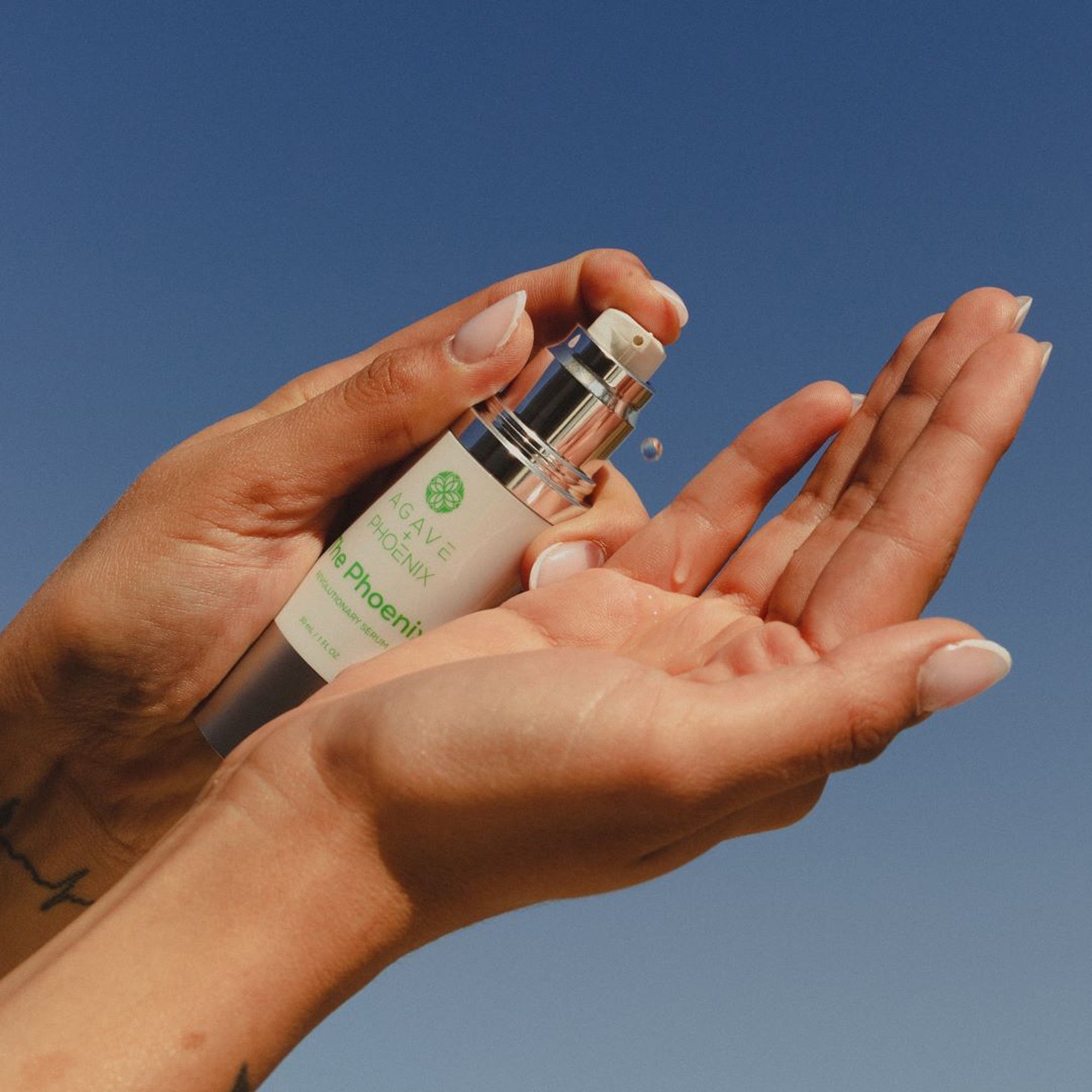 The Phoenix serum formula in hand — hydrating and anti-aging formula for radiant, balanced skin.