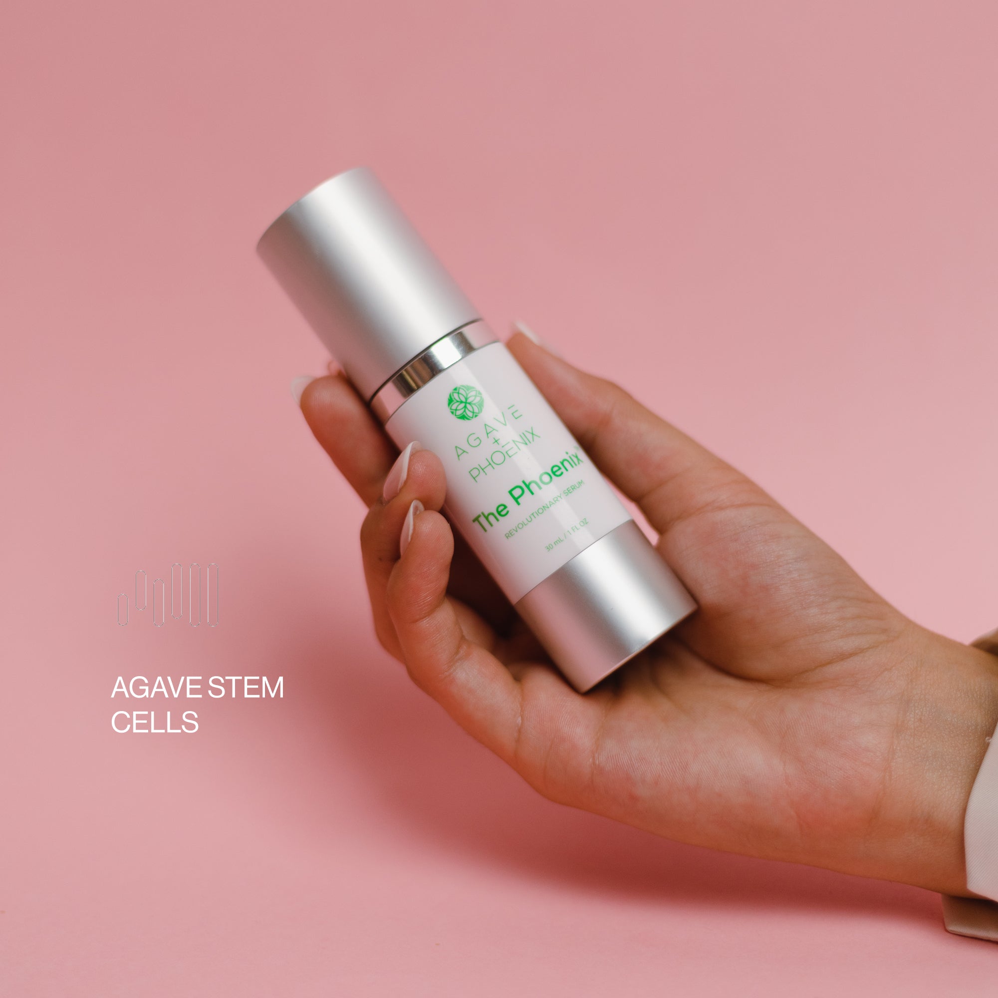 Hand holding The Phoenix serum bottle — a gentle, hydrating anti-aging treatment with agave stem cells.
